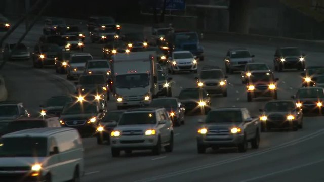Static shot of traffic on the freeway while the scene darkens in Atlanta, Georgia.