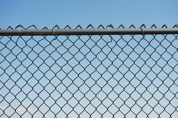iron chainlink fence against sky