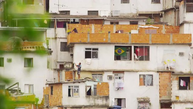 RIO DE JANEIRO, BRAZIL - JUNE 23: Static shot of people on rooftops in favela Rio de Janeiro, 2013