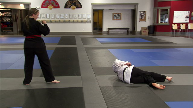 Martial arts instructor getting flipped over by his student.