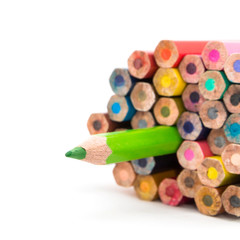 a green pencil with a sharp tip from sharpening,
differentiation abstract