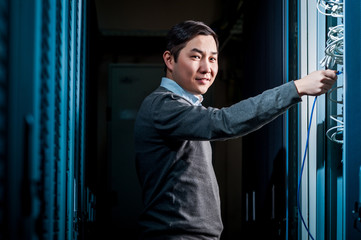 Young engineer businessman in server room