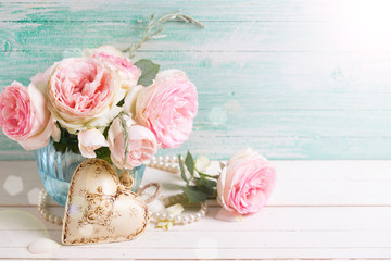 Pink roses flowers  in vase  and decorative heart