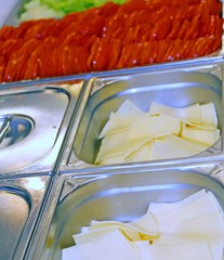 steel tray canteen with sliced cheese tomato and green lettuce