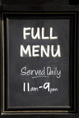 Menu sign serving food between 11am to 9pm