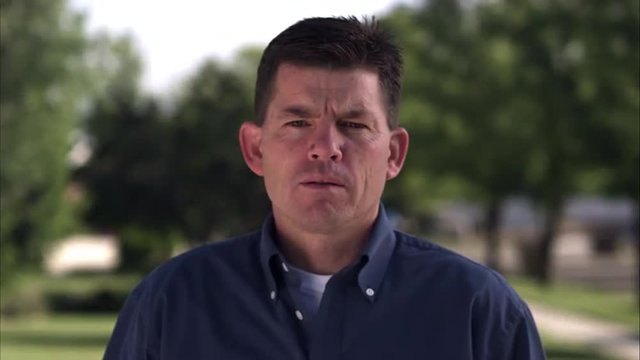 Static shot of an expressionless middle-aged man.