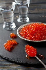 Red salmon caviar on black background