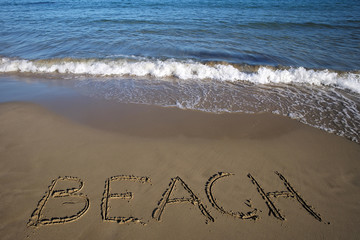 Beach written on wet sand