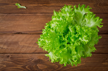 Fresh, green lettuce on a wooden background