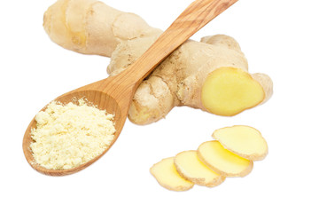 Ginger powder in spoon against the backdrop of ginger root