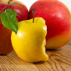 Image of ripe apples on a wooden board closeup