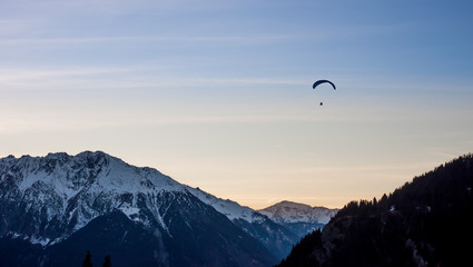 Sunset  vith paraglide over winter Alps