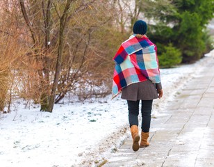 Girl walking by sidewalk at winter