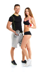 Athletic man and woman with dumbbells on the white