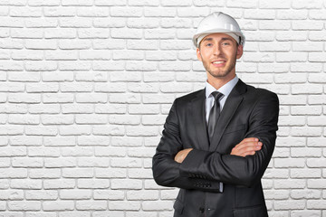 Young handsome engineer in white hardhat
