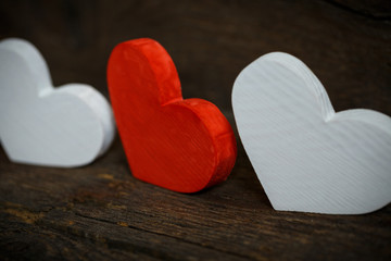 Red and white hearts on old wooden background