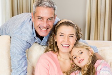 Happy family sitting together on a couch