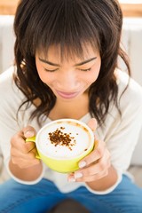 Pretty woman enjoying a cappuccino 