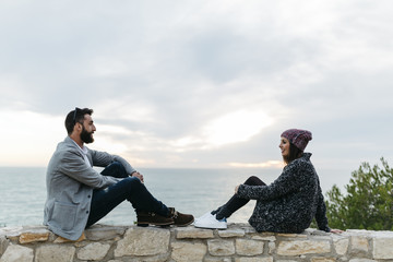 Young couple with lights in the evening by the sea