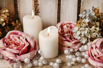 Romantic floral arrangement with roses and candles