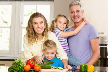 Happy family slicing vegetables