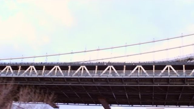 Dolly shot going under a bridge in New York City.