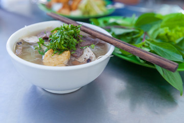 Vietnamese Pho noodle soup served with fresh herbs