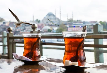 Poster Turkish tea cup on the background of port in Istanbul © seqoya