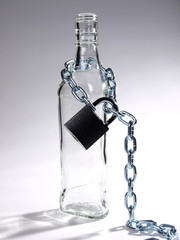 Wineglass of whiskey and metal chain