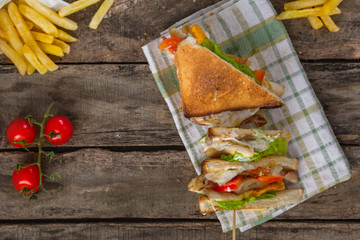 Concept of club sandwich on wooden table. Top view.