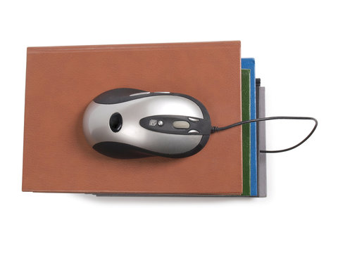 Stack of books and mause on white background