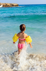 Happy child on the coast of tropical sea