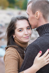 Loving couple hugging on the rocky beach