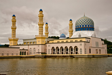 Kinabalu City Mosque. Facade with a wide entrance arch is made of gleaming white marble , and the interior surface of the walls are lined with colored marble