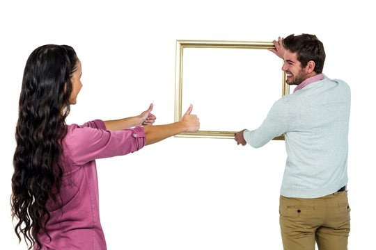 Smiling couple with picture frame