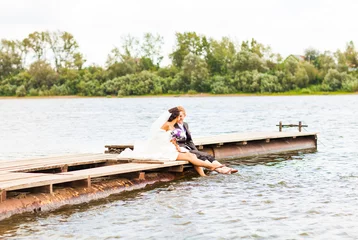 Foto op Canvas  wedding couple  on the pier near big lake © satura_