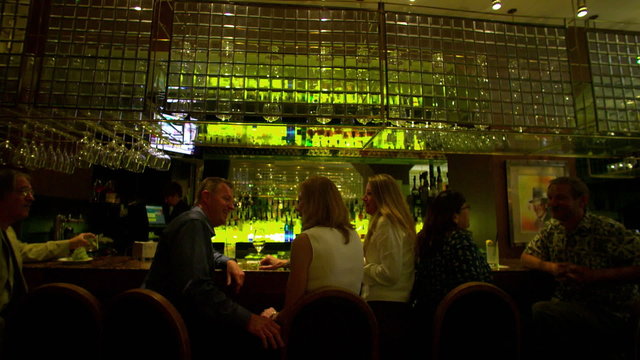 People seated at a bar in restaurant.