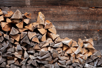Pile of firewood. Preparation of firewood for the winter. Backgr