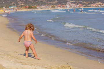 Little Girl Playing On The Beach