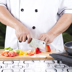 Chef cutting red bell pepper