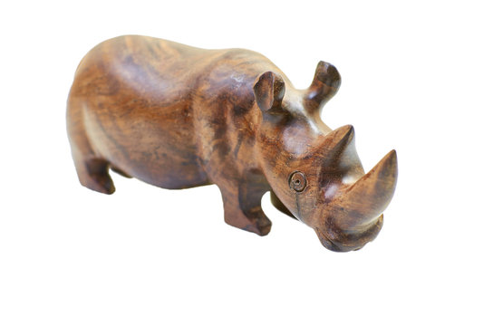 Rhinoceros rhino sculpture made of carved brown wood isolated over white background