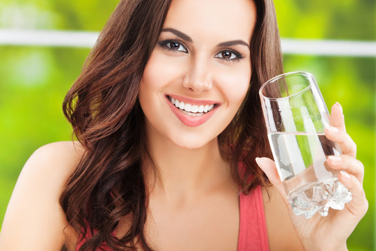 young happy woman with glass of water