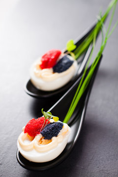 Appetizer on fingerspoon egg with caviar