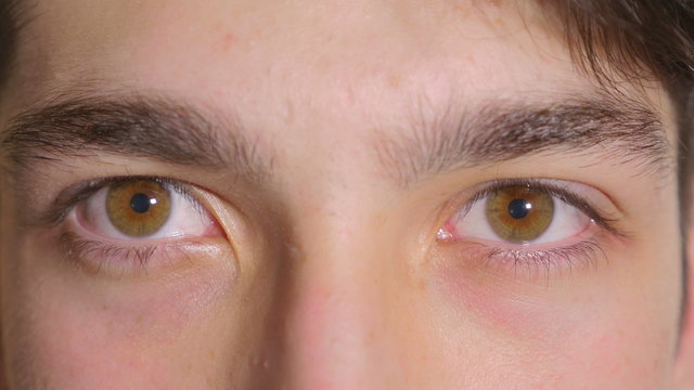 Close-up of man eyes opening scared