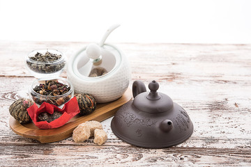 Tea cups with teapot on old wooden table