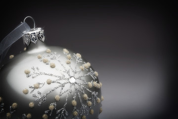 Silver tree decoration on a grey to black background