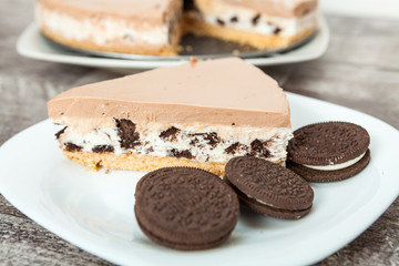 Fototapeta na wymiar Creamy cheesecake with chocolate cookies and cream biscuits