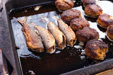 Cod (Dorsch) filets and frikadeller (frikadelle) cooking in oil
