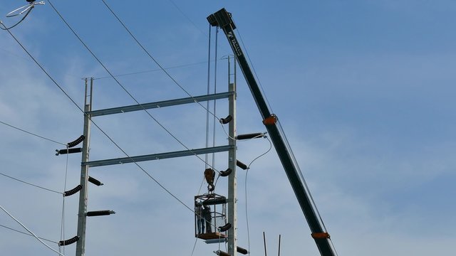 Workers are installing high-voltage electricity pole3