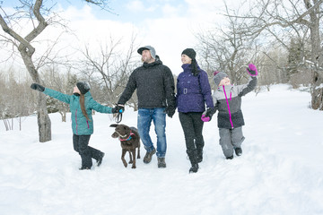 Happy parents and their kids in winterwear